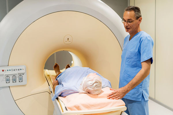 photo of a radiologist talking to a senior man who is about to have a scan for prostate cancer